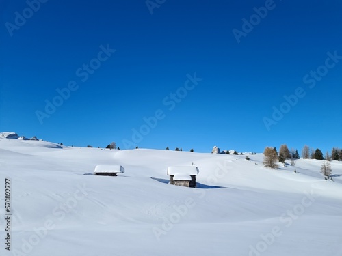 Amazing winter landscape in Italian Alps. Winter panorama with ski huts in the snow. beautiful bright sky in winter wonderland alps. © Cornelia