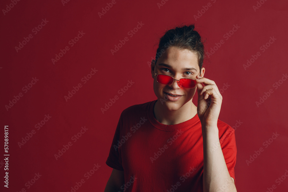 Young cute man in red-framed eyeglasses looking at camera Young cute man in red-framed eyeglasses looking at camera