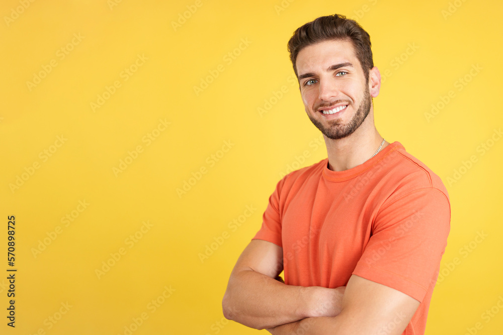 Handsome man standing whit arms crossed smiling at the camera Handsome man standing whit arms crossed smiling at the camera
