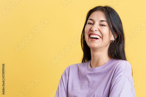 Happy woman laughing and looking at the camera