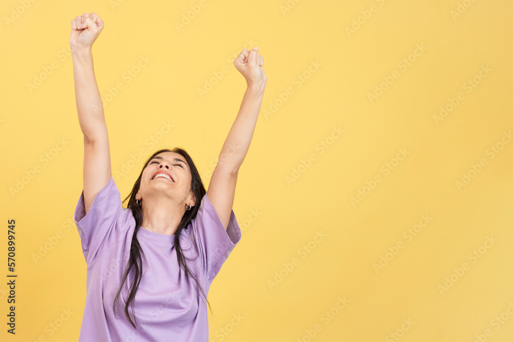 Happy hispanic woman celebrating while raising arms Happy hispanic woman celebrating while raising arms