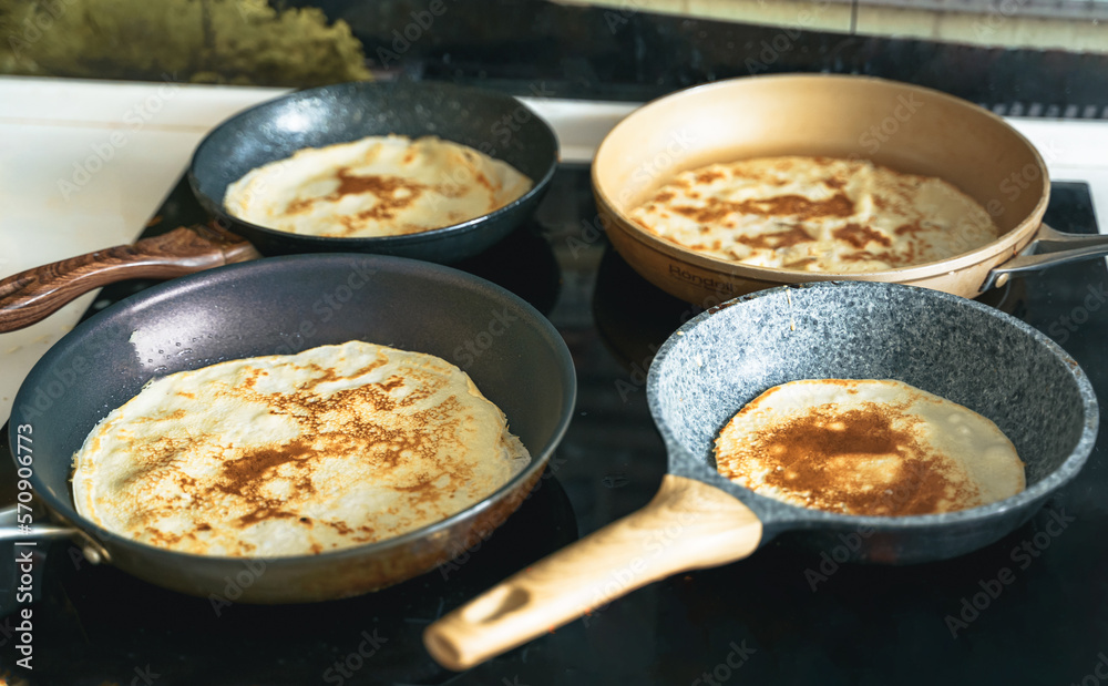 Russia Moscow 14.03.2021 Cooking many big tasty pancakes Lot of pans,oil,pancake dough.Russian traditional national festival winter Maslenitsa holiday week,shrovetide. Man, father cook.Family holiday Russia Moscow 14.03.2021 Cooking many big tasty pancakes Lot of pans,oil,pancake dough.Russian traditional national festival winter Maslenitsa holiday week,shrovetide. Man, father cook.Family holiday