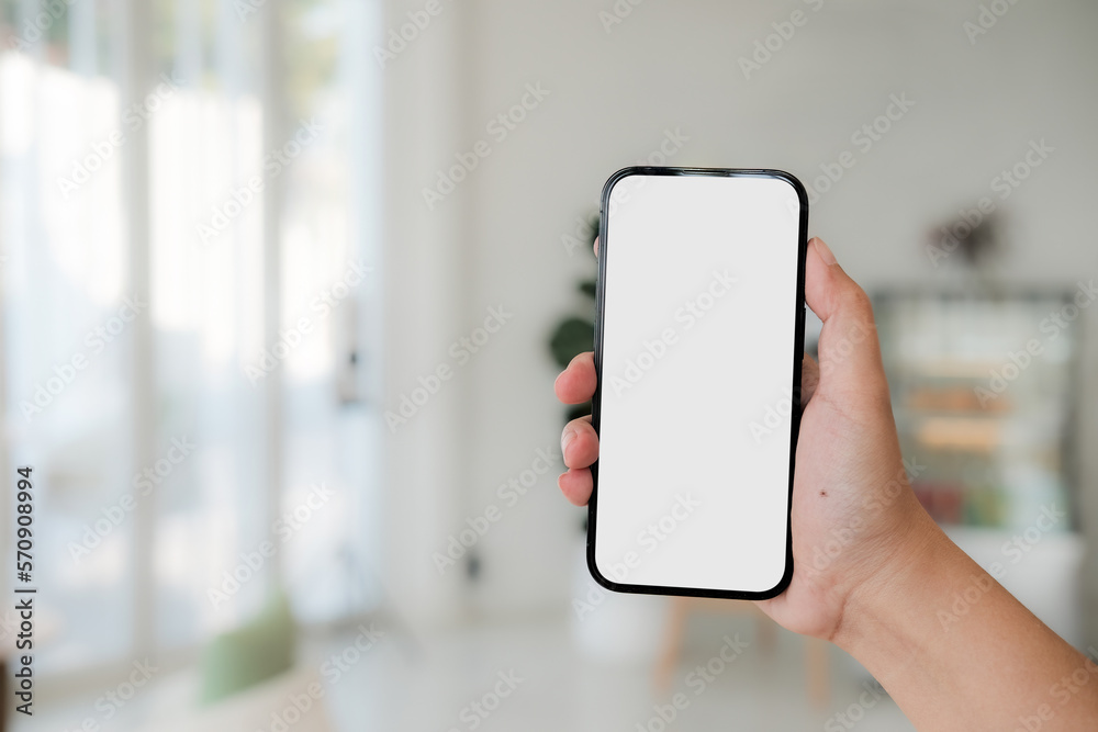 Mock up phone in woman hand showing white screen. Mobile phone white screen is blank the background is blurred