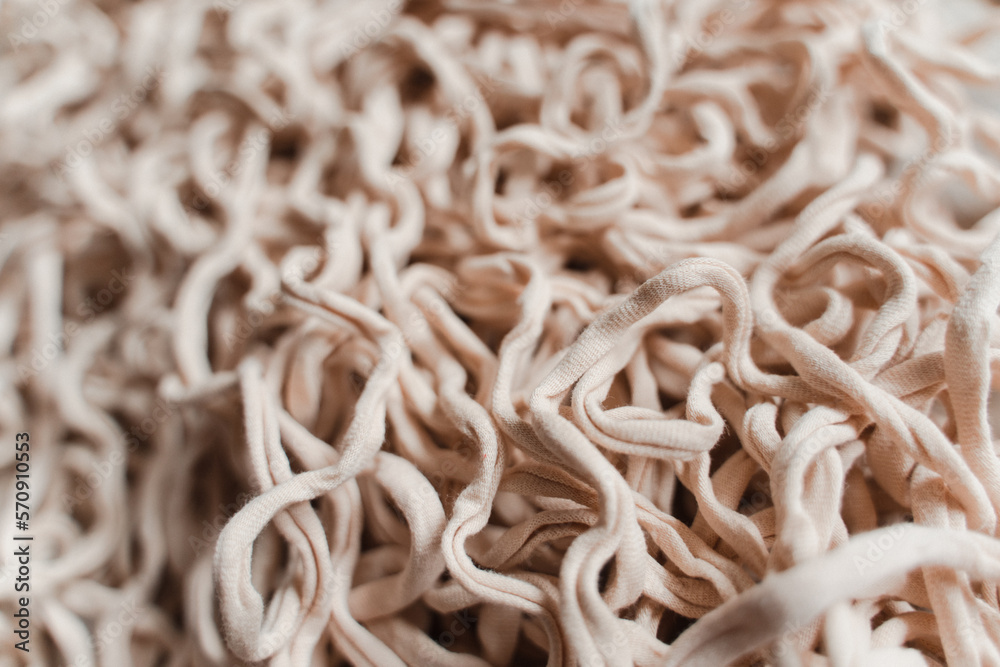Tangled beige threads yarn noodles texture background Tangled beige threads yarn noodles texture background