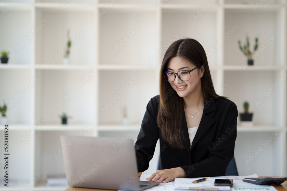 Portrait of young Asian businesswoman working with laptop computer in the office room. Portrait of young Asian businesswoman working with laptop computer in the office room.