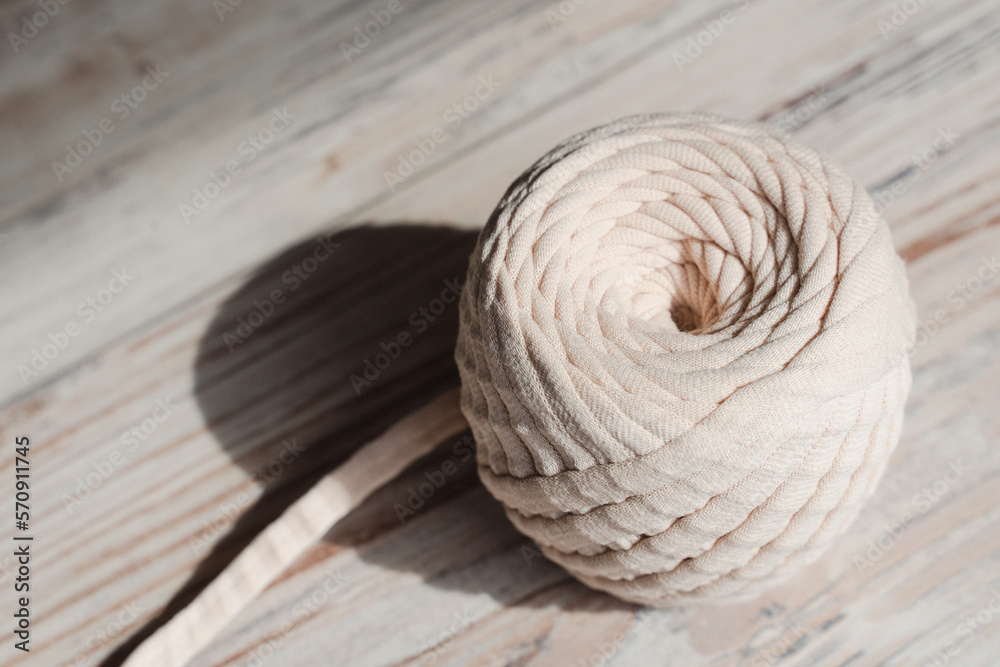 Fototapeta premium Skein of threads of beige noodle yarn, close-up
