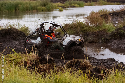athlete on a ssv rides in the mud