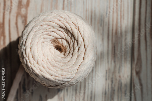 Skein of threads of beige noodle yarn, close-up