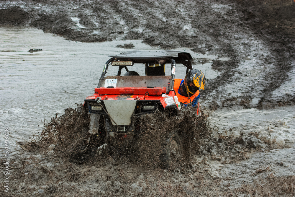 athlete on a ssv rides in the mud athlete on a ssv rides in the mud