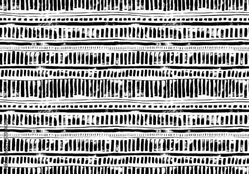 Brush drawn geometric seamless pattern in native style. Ethnic or tribal ornament with black and white thin lines and bold dashes. Horizontal stripes with vertical vector dashes. Aztec native ornament