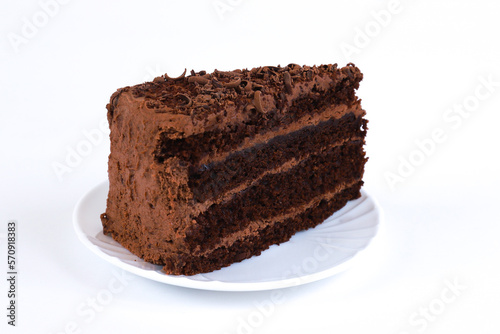 A piece of chocolate cake on a white background. Shallow depth of field