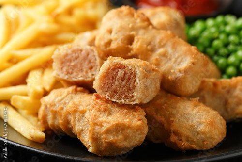 Irish battered sausages with potato fries, green peas and ketchup