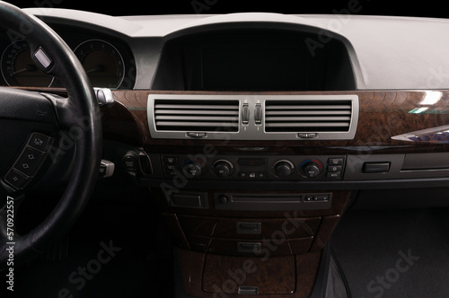 Classic prestige car inside. Multimedia screen and control buttons.