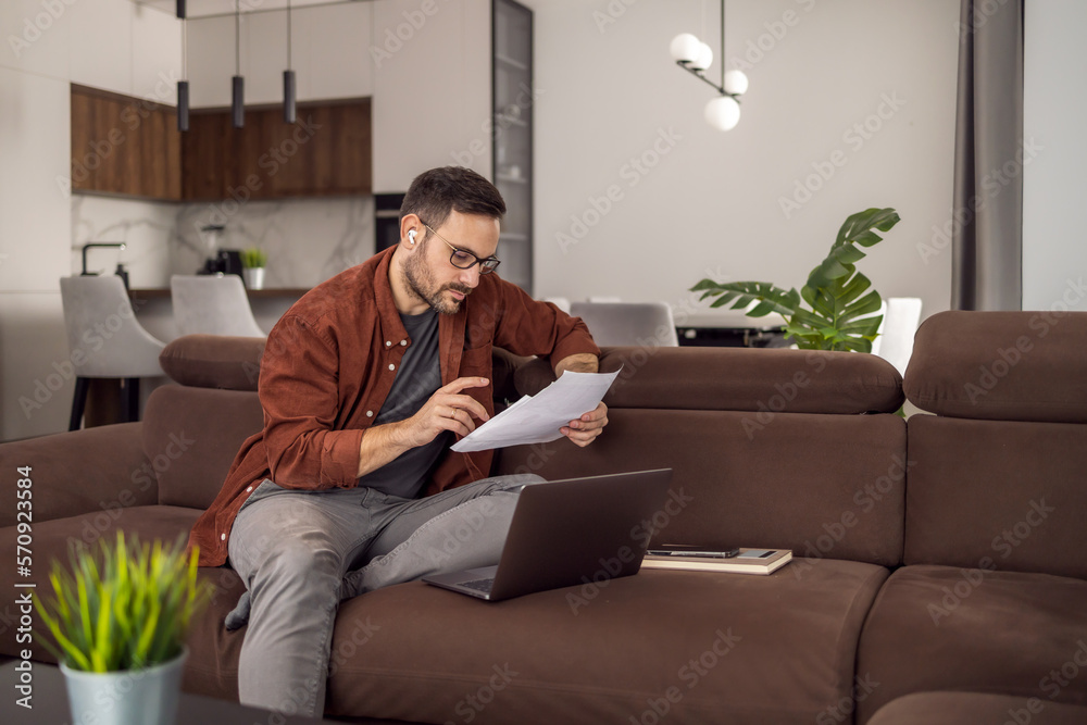 People,technology and business concept,man with laptop working at home office