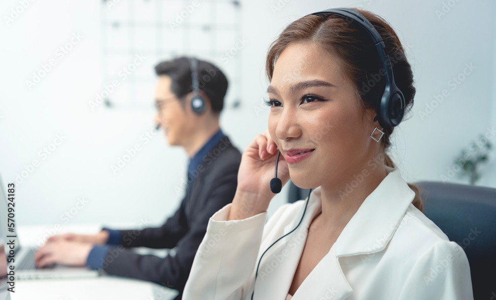 Asian call center agent team, customer service support wearing headset or headphone talking with customer in modern office. Asian call center agent team, customer service support wearing headset or headphone talking with customer in modern office.