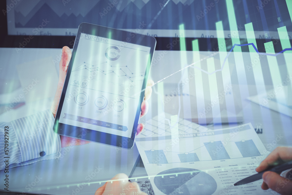 Double exposure of man's hands holding and using a digital device and forex graph drawing. Financial market concept. Double exposure of man's hands holding and using a digital device and forex graph drawing. Financial market concept.