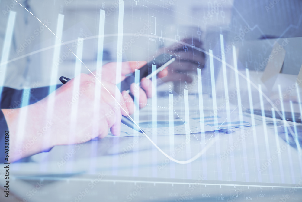 Double exposure of man's hands holding and using a phone and financial chart drawing. Market analysis concept. Double exposure of man's hands holding and using a phone and financial chart drawing. Market analysis concept.