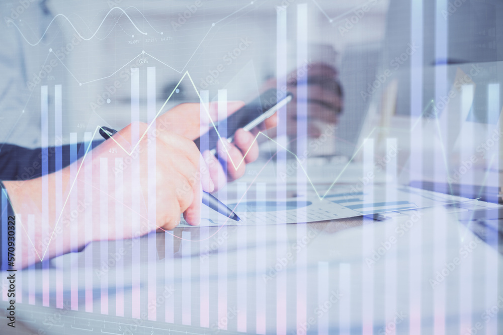 Double exposure of man's hands holding and using a phone and financial chart drawing. Market analysis concept. Double exposure of man's hands holding and using a phone and financial chart drawing. Market analysis concept.