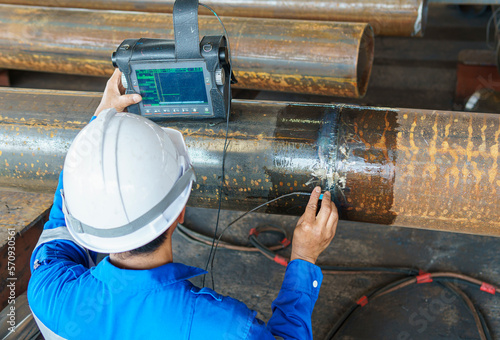 Inspectors Check Defects in Welded add Joints of Steel Pipe with Process Ultrasonic testing (UT) of Non-Destructive Testing(NDT)