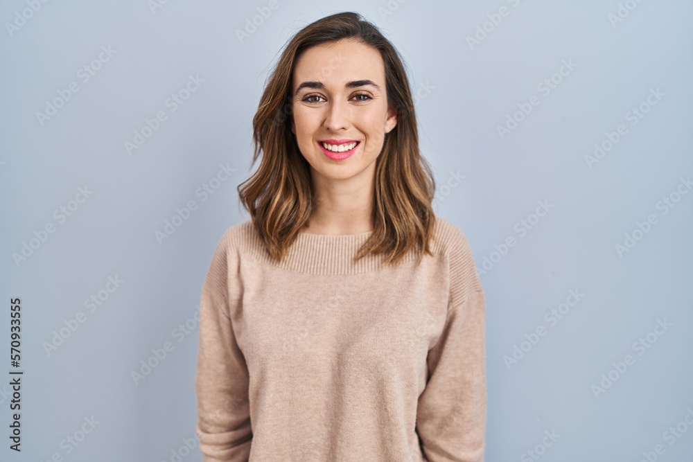 Young woman standing over isolated background with a happy and cool smile on face. lucky person.