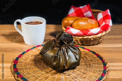 Typical Colombian lunch of Tamal with chocolate and bread, traditional colombian food photo