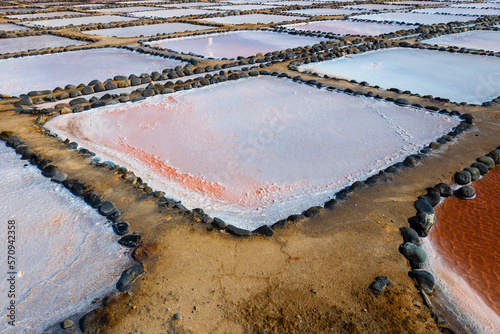 Gran Canaria, Salinas de Tenefe salt evaporation ponds, southeastern part of the island, pink color created by Dunaliella salina algae photo