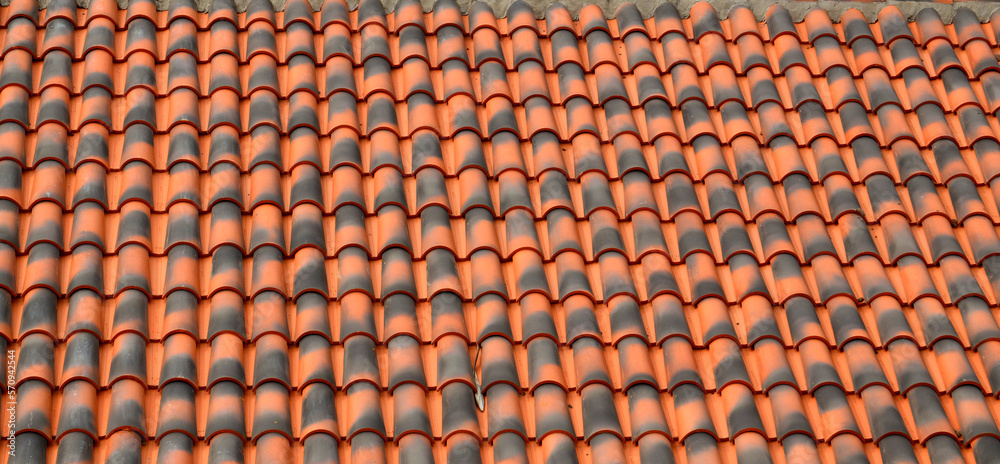 Red brown ceramic tile texture background.Roof of a house with modern shingles.Selective focus.