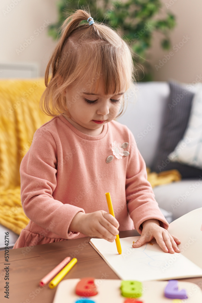 Adorable blonde girl drawing on notebook at home Adorable blonde girl drawing on notebook at home
