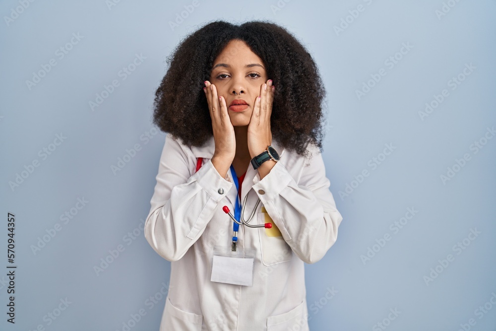 Young african american woman wearing doctor uniform and stethoscope tired hands covering face, depression and sadness, upset and irritated for problem Young african american woman wearing doctor uniform and stethoscope tired hands covering face, depression and sadness, upset and irritated for problem