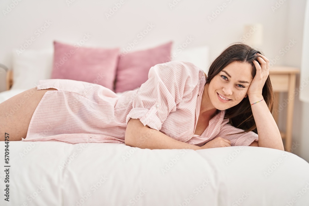 Young woman smiling confident lying on bed at bedroom Young woman smiling confident lying on bed at bedroom