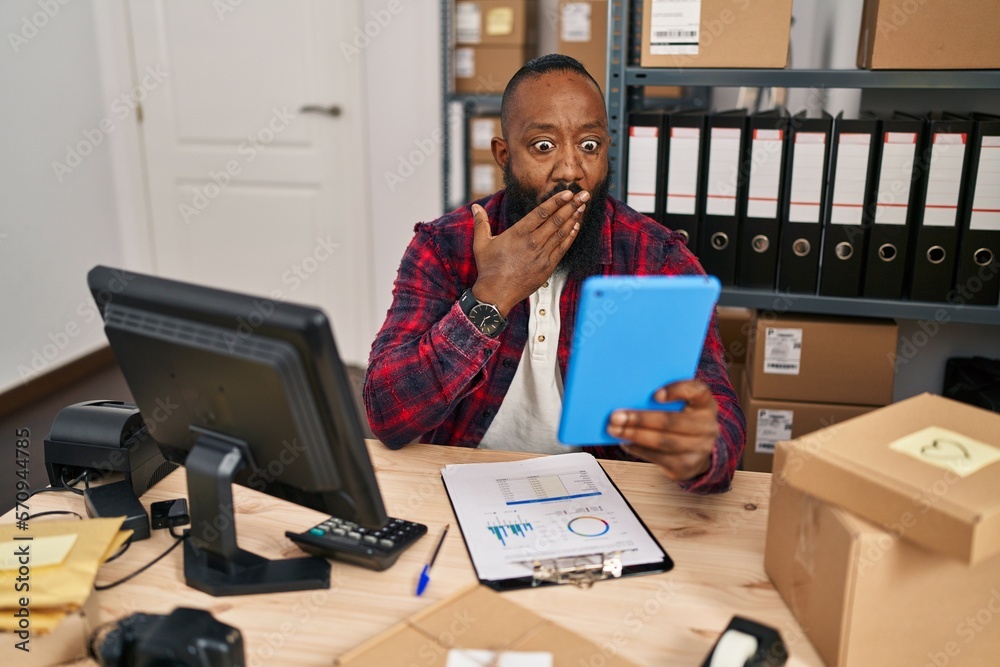 African american man working at small business ecommerce doing video call covering mouth with hand, shocked and afraid for mistake. surprised expression African american man working at small business ecommerce doing video call covering mouth with hand, shocked and afraid for mistake. surprised expression