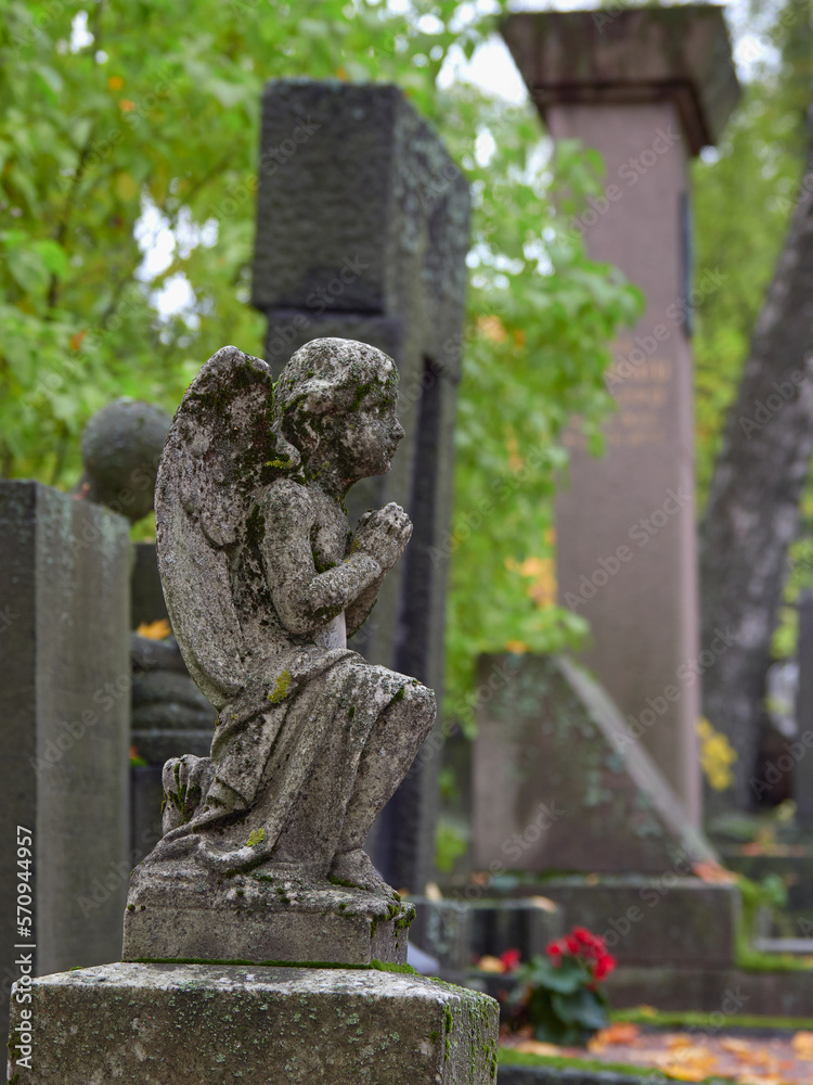 Old sculpture in European cemetery: Finland, Helsinki, Hietaniemi, autumn.