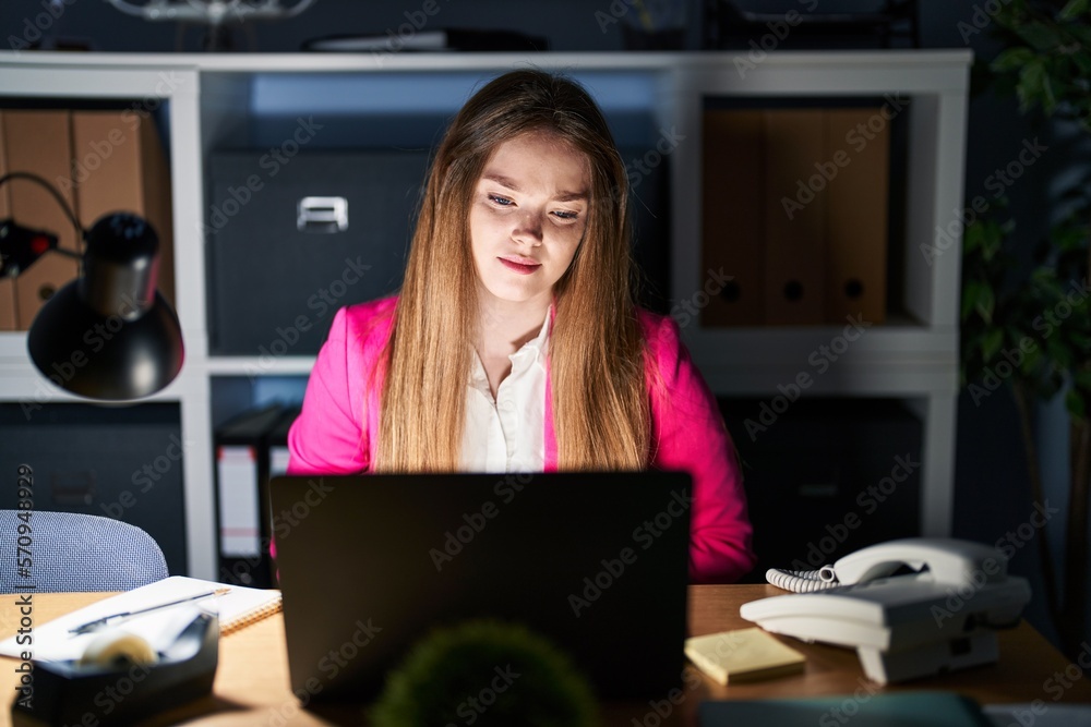 Young caucasian woman working at the office at night with hand on stomach because indigestion, painful illness feeling unwell. ache concept. Young caucasian woman working at the office at night with hand on stomach because indigestion, painful illness feeling unwell. ache concept.