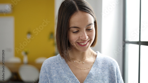 Young beautiful hispanic woman smiling confident standing at home