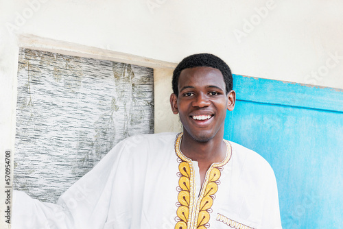 Well-dressed young man ready for a celebration, embroidered white and yellow garment, 19 years old, photo photo