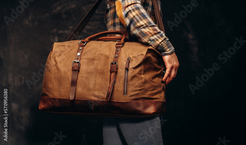 Brown duffel bag on men's shoulder photo