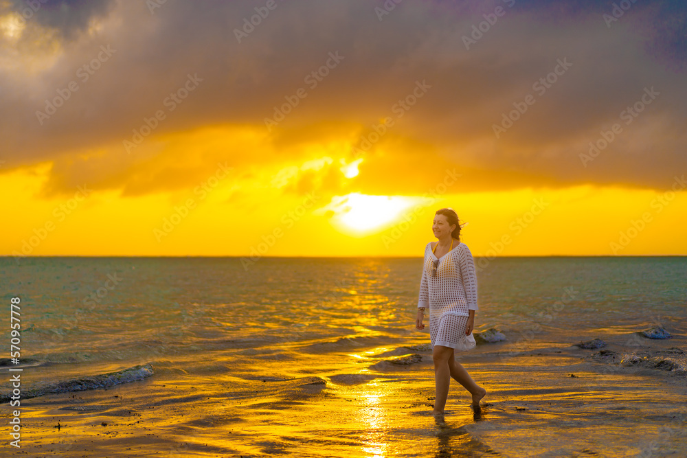 Fototapeta premium Beach holiday - woman walking on sunny, tropical beach