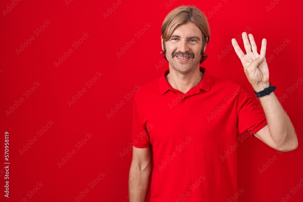 Caucasian man with mustache standing over red background showing and pointing up with fingers number four while smiling confident and happy. Caucasian man with mustache standing over red background showing and pointing up with fingers number four while smiling confident and happy.