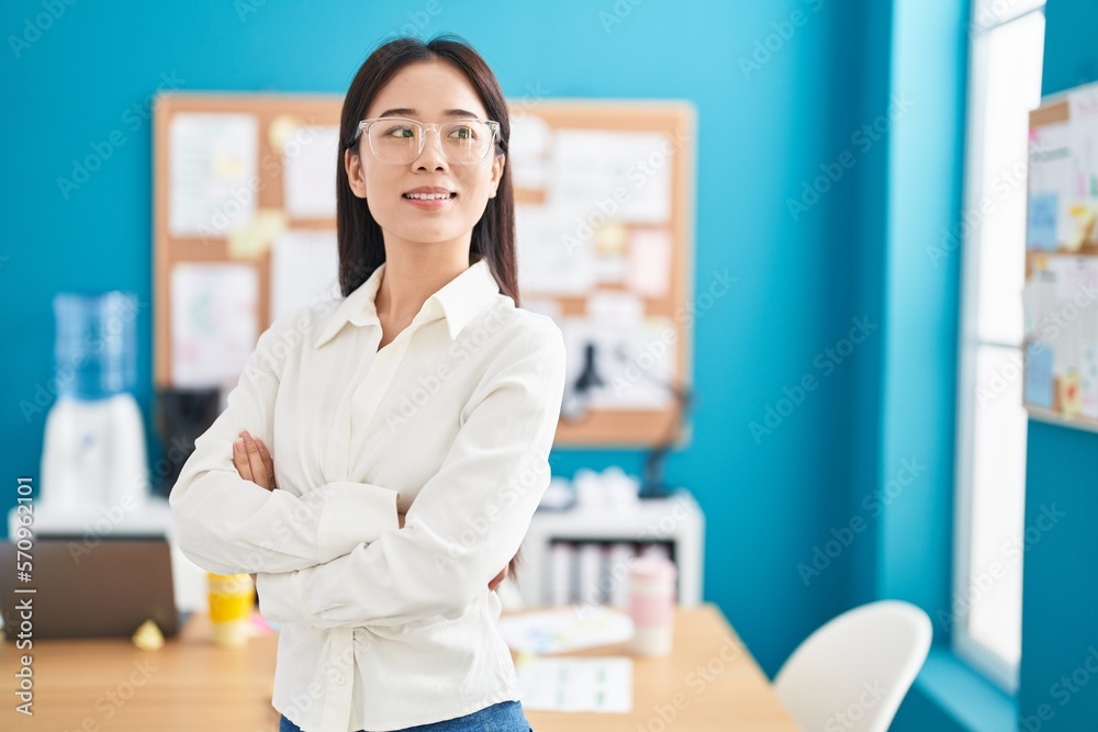 Young chinese woman business worker smiling confident standing with arms crossed gesture at office Young chinese woman business worker smiling confident standing with arms crossed gesture at office