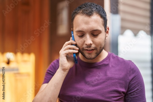 Young man talking on the smartphone at street