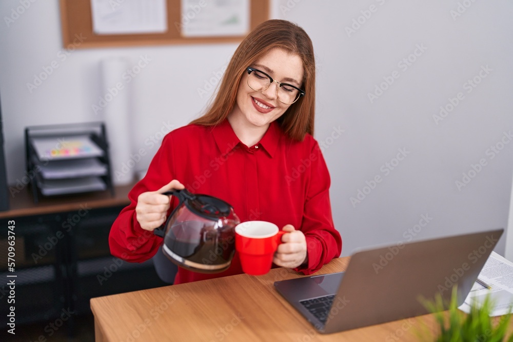 Young redhead woman business worker pouring coffee on cup at office Young redhead woman business worker pouring coffee on cup at office
