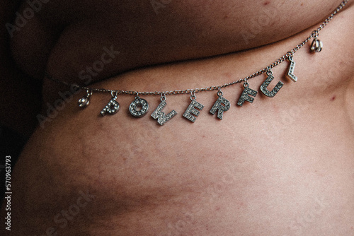 close up of tummy rolls with POWERFUL body chain