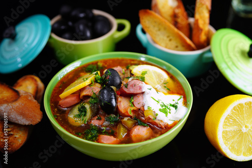 Solyanka, soup with olives and lemon. Russian kitchen. Beautiful background.