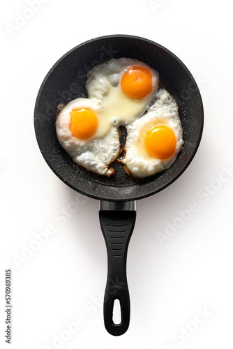 Frying pan with scrambled eggs from 3 eggs on a white background. isolate