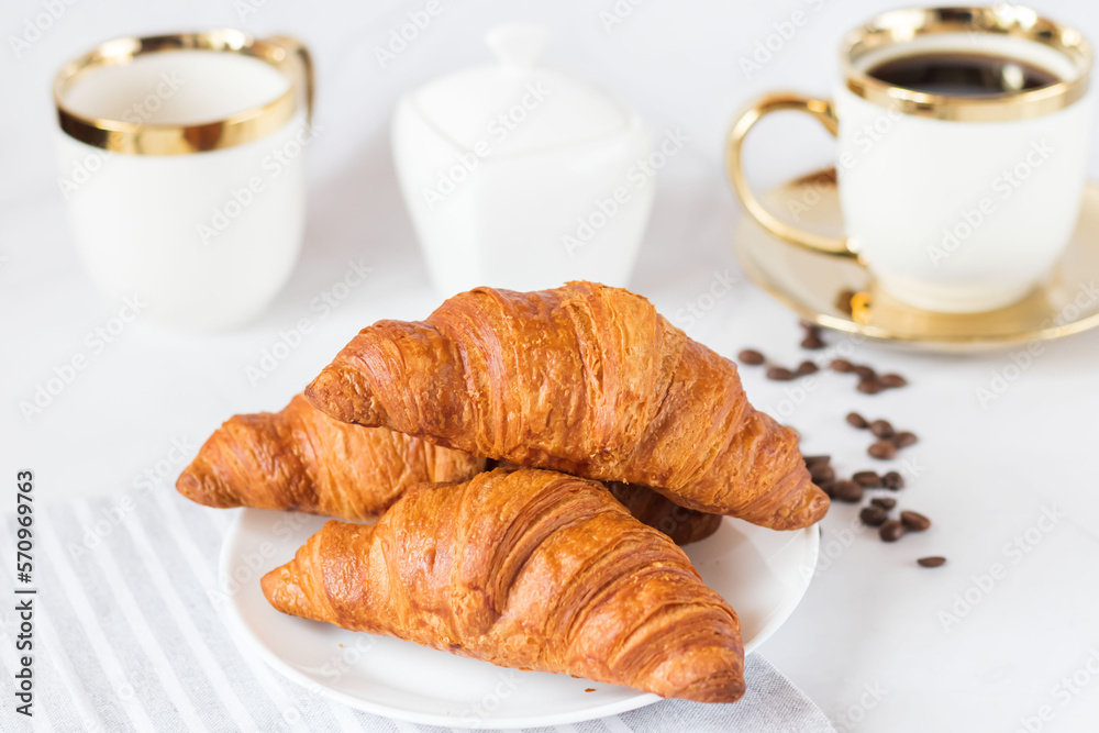 Morning with a cup of coffee and croissants. On a white background. Breakfast. Morning with a cup of coffee and croissants. On a white background. Breakfast.