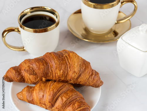 Morning with a cup of coffee and croissants. On a white background. Breakfast.