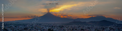 View on th Popocatepetl Volcano during sunset from the ancient pyramid of Cholula, Mexico photo