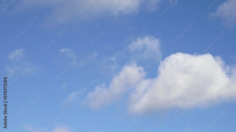 White fluffy cumulus clouds are flying, fast moving blue sky on a cloudy winter day. Blue sky white clouds. Cumulus cloud cloudscape timelapse. Fast moving white clouds and blue sky. White fluffy cumulus clouds are flying, fast moving blue sky on a cloudy winter day. Blue sky white clouds. Cumulus cloud cloudscape timelapse. Fast moving white clouds and blue sky.