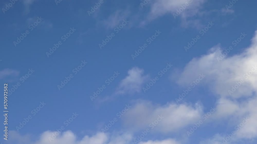White fluffy cumulus clouds are flying, fast moving blue sky on a cloudy winter day. Blue sky white clouds. Cumulus cloud cloudscape timelapse. Fast moving white clouds and blue sky. White fluffy cumulus clouds are flying, fast moving blue sky on a cloudy winter day. Blue sky white clouds. Cumulus cloud cloudscape timelapse. Fast moving white clouds and blue sky.