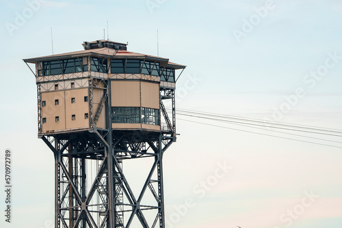 Low angle view of Torre Sant Sebastia a aerial tramway with cables and restaurant on top of tower with clear sky in the background at Catalonia in Barcelona, Spain photo